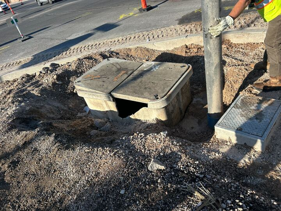 Underground Fiber and Power Infrastructure Maintenance Technician repairing underground utility infrastructure and access boxes for fiber and power systems