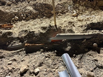 Underground Fiber and Power Utility Repairs Damaged underground fiber or power utility line exposed during emergency repair excavation
