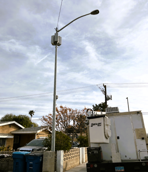 Small Cell and Broadband Telecommunications Infrastructure Small cell telecommunications equipment installed on utility pole for broadband network expansion